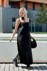 a lady in a black long slip dress made of xiangyun silk